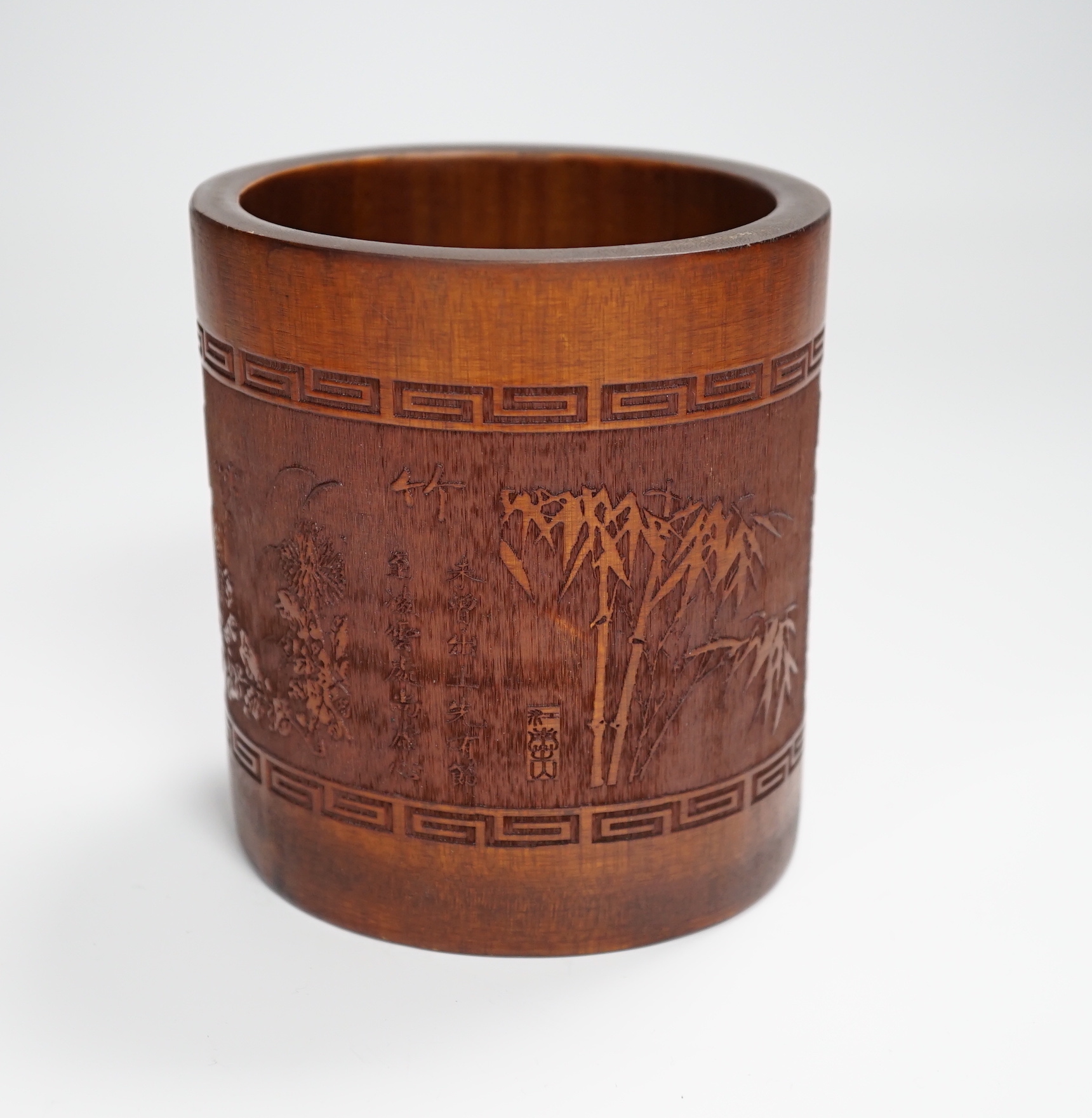 A 20th century bamboo bitong, carved with Chinese characters, bamboo and other foliage, 11.5cm high